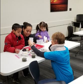 Two kids, their mother, and ASCE volunteer Lisa Denke.